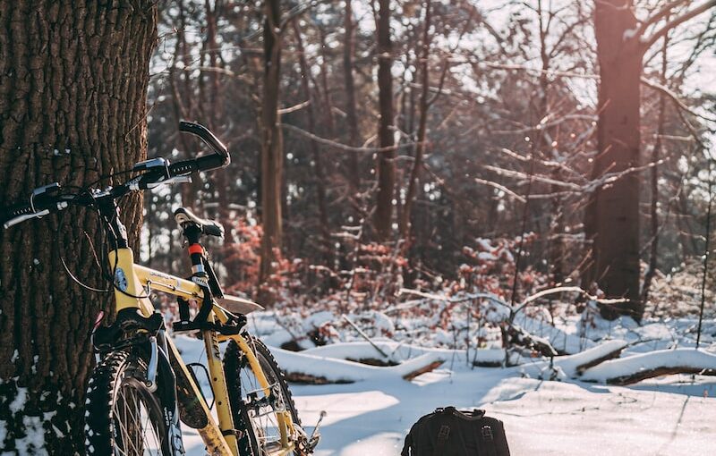 yellow and black bicycle on snow covered ground during daytime