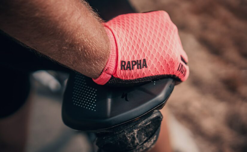 person wearing pink Rapha gloves