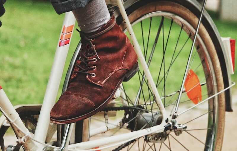 person wears brown suede dress shoe