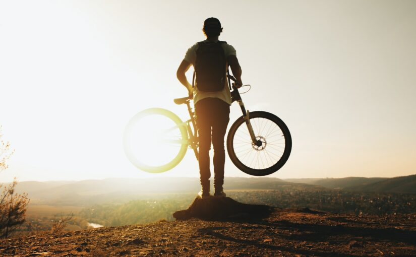 man carrying bike