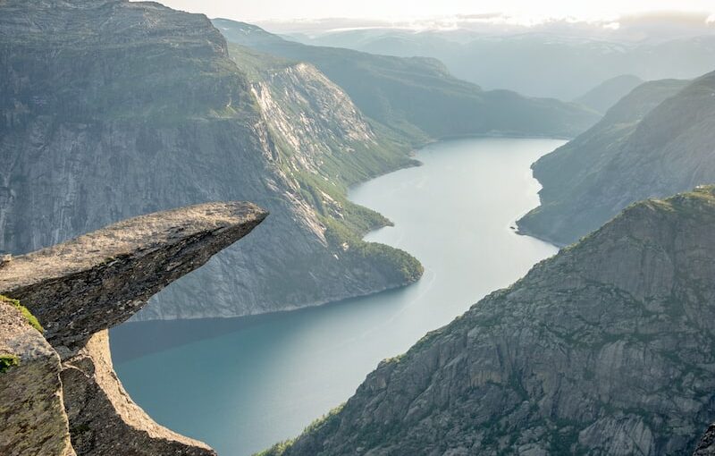 photo of mountain and ocean scenery