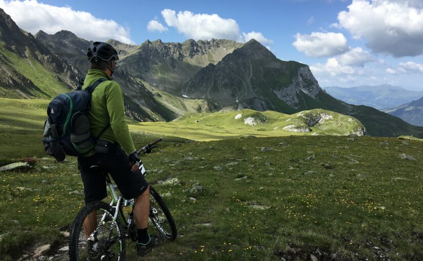 man riding bicycle on top of mountain